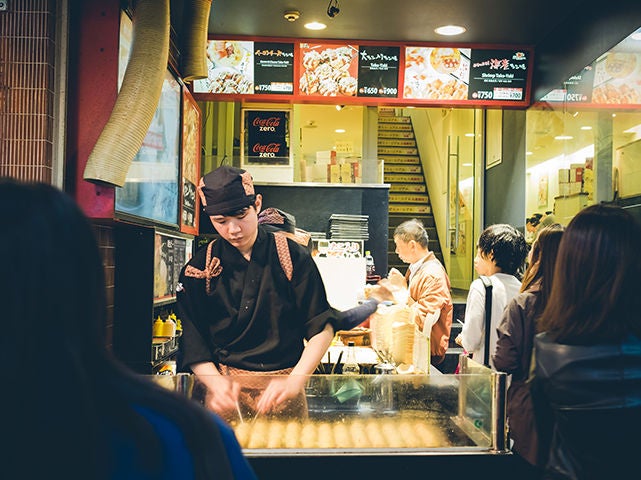 OSAKA, JAPAN - SEPTEMBER, 1: Unidentified Chefs prepare takoyaki for customers in front of their restaurant on SEPTEMBER 1,2015. Dotonbori is the most famous nightlife and food area for tourist., OSAKA, JAPAN - SEPTEMBER, 1: Unidentified Chefs prepare takoyaki OSAKA, JAPAN - SEPTEMBER, 1: Unidentified Chefs prepare takoyaki for customers in front of their restaurant on SEPTEMBER 1,2015. Dotonbori is the most famous nightlife and food area for tourist.